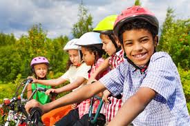 picture of children on bicycles wearing helmets